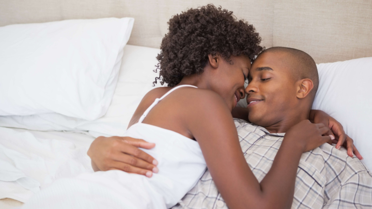 Couple intimately embracing in bed