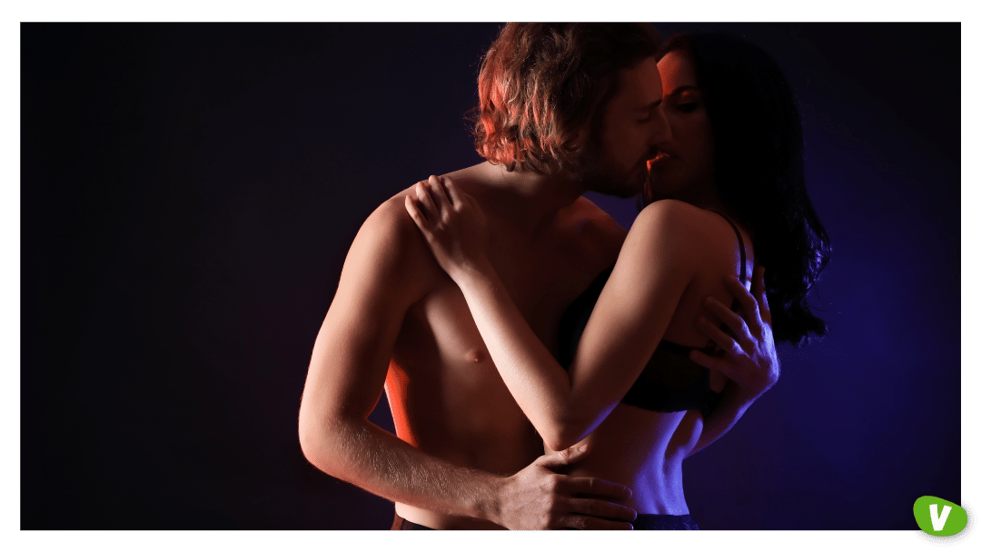 Passionate Young Couple on Dark Background about to Kiss