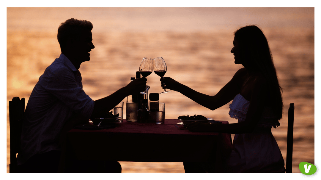 Couple sharing romantic sunset dinner on the beach⁠