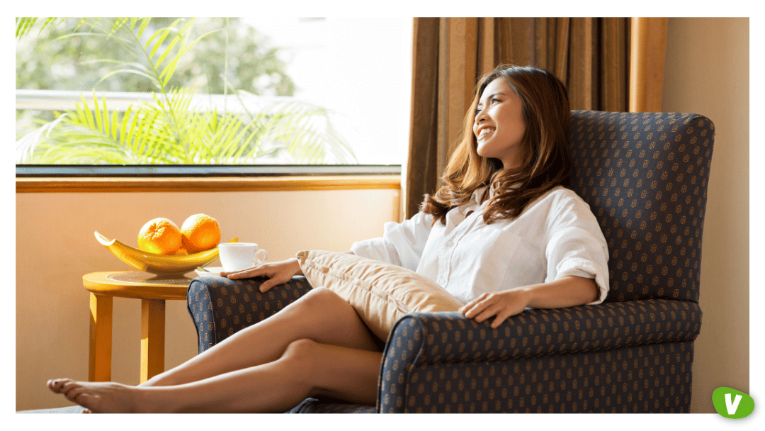 asian woman relaxing in an armchair