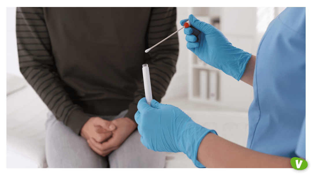 Doctor Taking Sample for STD Testing from Man in Clinic, Closeup