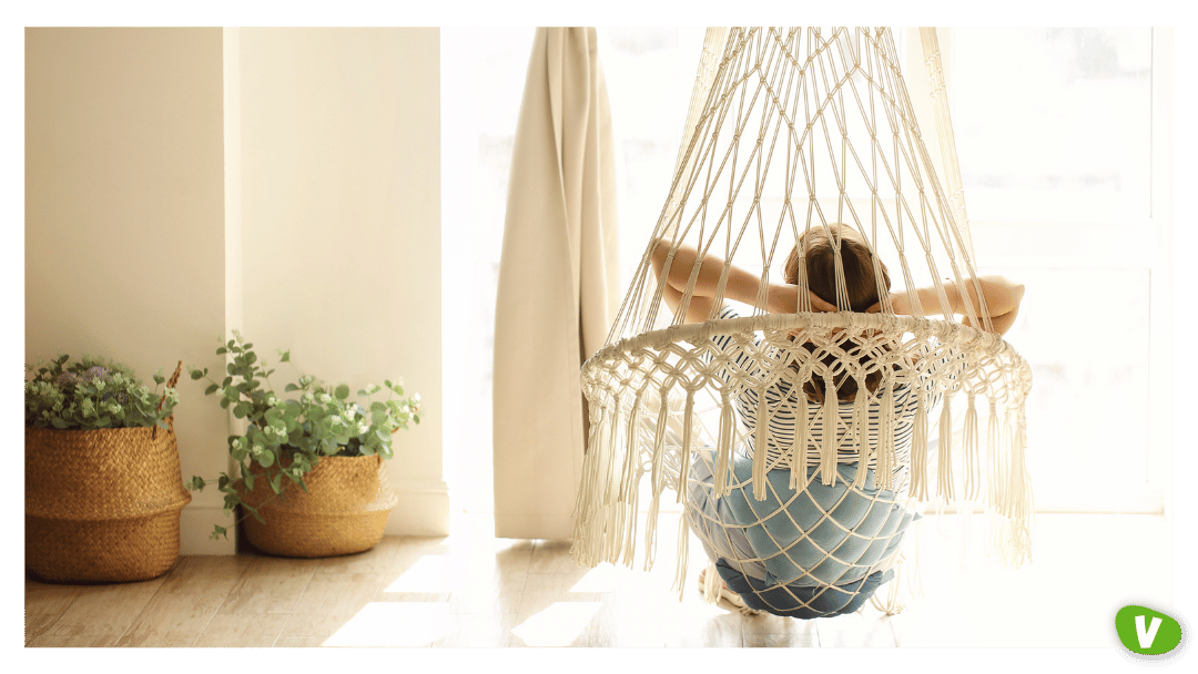 Woman Relaxing in Hanging Chair at Home