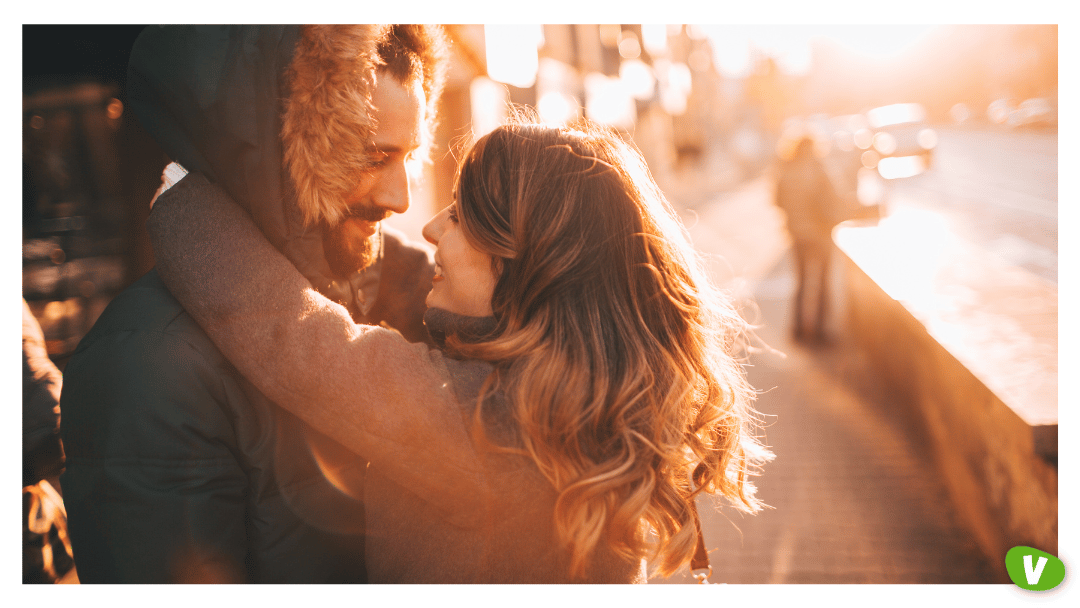 a couple hugging outside on a sunny winter afternoon