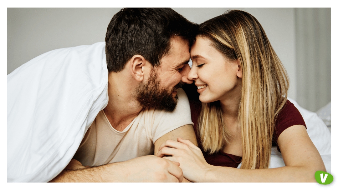 young couple loved up in bed